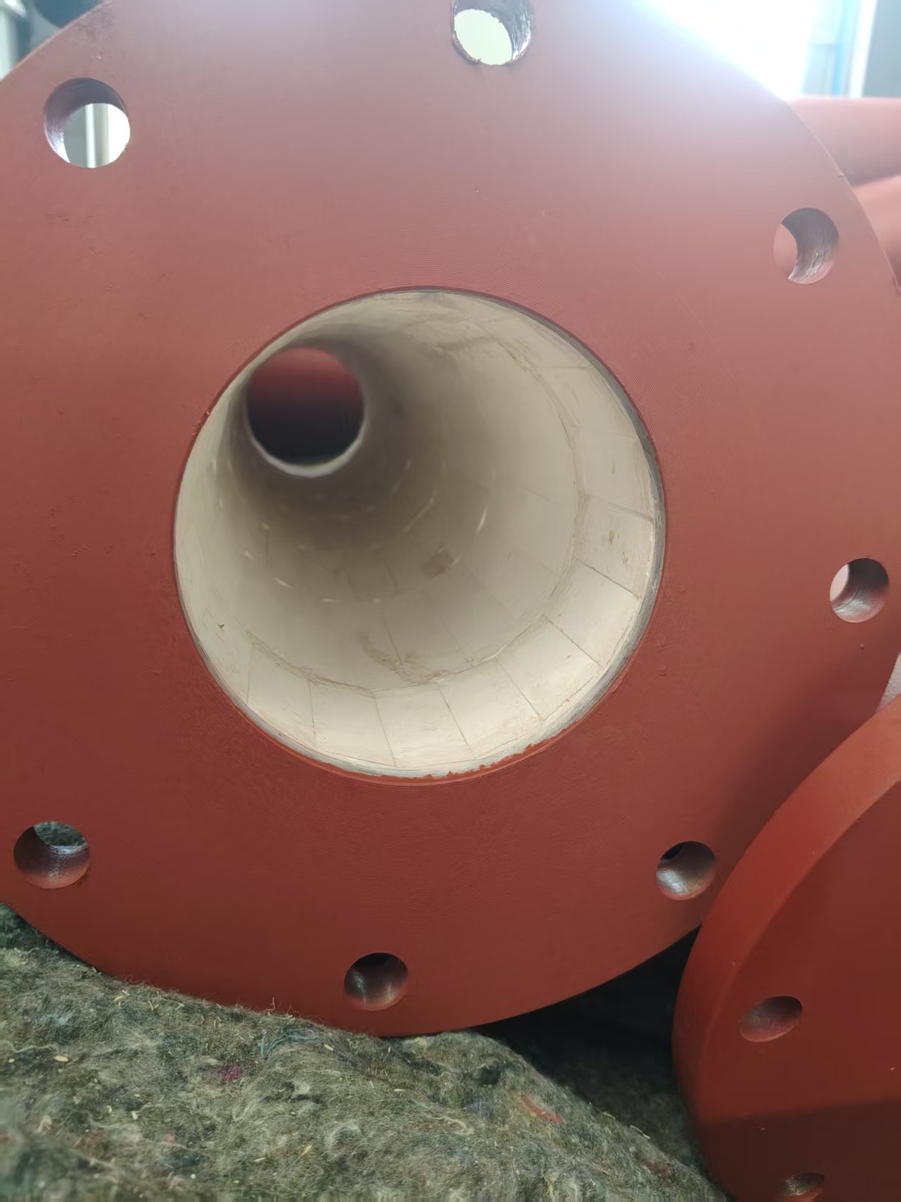 Supplied photograph: red flanged pipe with ceramic lining